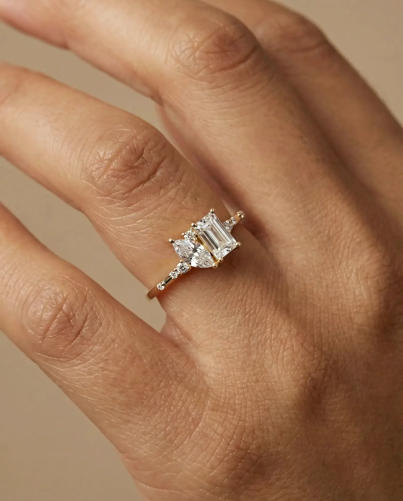 Close-up of a hand wearing a gold-plated silver ring with clear stones