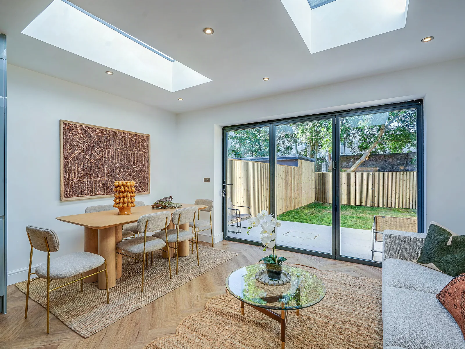 Dining area with skylights and sliding doors onto the garden